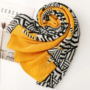 Close-up of pleated scarf with yellow and zebra print pattern for autumn style