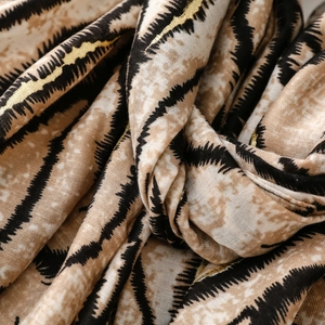 Detail of zebra pattern scarf showing soft cotton-linen texture and gold foil printing