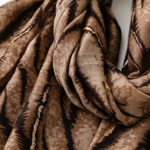 Macro detail of zebra print shawl with soft texture and golden lurex metallic threads