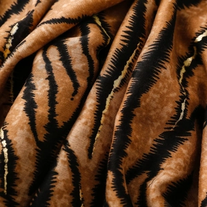 Detail of soft scarf featuring zebra stripes and golden foil print on linen-feel fabric