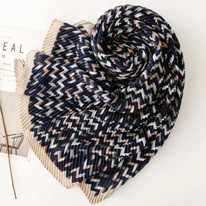 Macro detail of pleated navy blue and pink geometric pattern scarf with textured edges