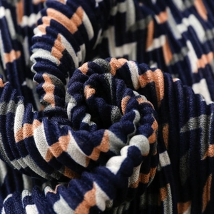 Pleated scarf with geometric navy and coral zig-zag pattern and textured fabric