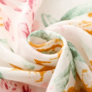 Macro detail of twill cotton linen scarf showing soft floral print and fine fabric texture