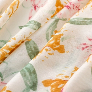 Macro detail of twill fabric showing elegant orange flower patterns and textile texture