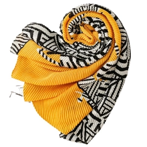Pleated mustard yellow scarf with black and white zebra patterns folded in a heart shape