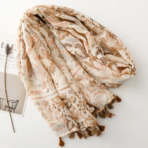 Close-up of bohemian floral leaf print scarf with brown tassel fringe decorations