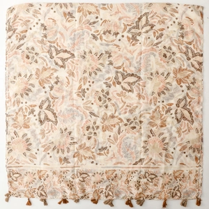 Detail view of ethnic floral print square scarf with decorative brown and beige tassels
