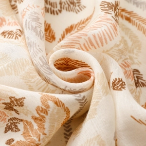 Macro shot of soft cotton fabric with feather prints showing breathable texture and weave