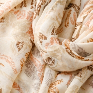 Close-up of lightweight floral scarf showing soft fabric texture and detailed feather pattern