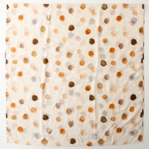 Detail view of lightweight scarf with colorful artistic polka dots and sheer texture