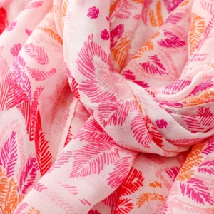 Macro shot of soft pink floral scarf showing lightweight texture and abstract patterns