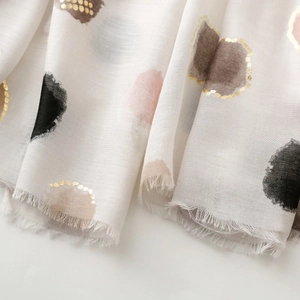 Detail of artistic watercolor polka dots and gold foil accents on lightweight cotton scarf