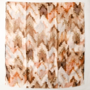 Close-up of lightweight scarf featuring gold foil accents and abstract wave patterns