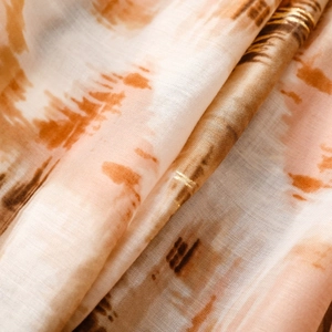 Detail of thin scarf featuring gold foil lines and artistic mountain pattern texture
