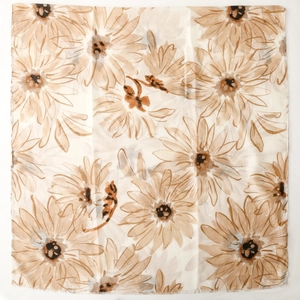 Detail of floral daisy print silk scarf featuring fine fringed edges on a beige background