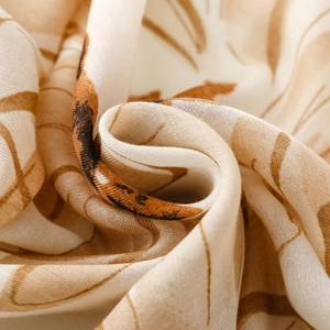 Macro shot of satin silk scarf fabric showing soft texture and abstract daisy floral prints