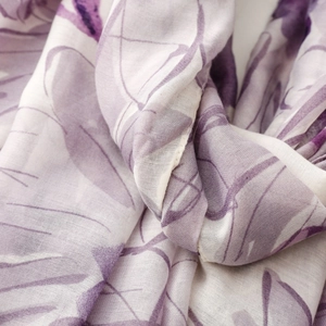 Detail shot of sheer purple floral silk scarf showing soft drape and fine fabric texture