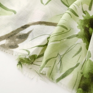 Detailed view of light green floral print scarf with soft eyelash fringe texture