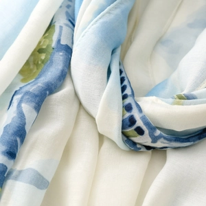 Detail of soft satin scarf with abstract watercolor pattern and fine rolled hem edges