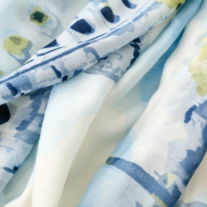 Detail of soft blue and white watercolor abstract silk scarf with fine cross-weave texture