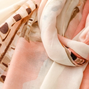 Close-up of abstract artistic print on soft satin scarf with delicate texture folds
