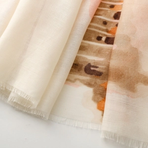 Detail of soft satin scarf with abstract Roman holiday print and fine tassel edges