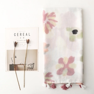 Detail of elegant floral scarf with pink and purple patterns and soft fringe edges