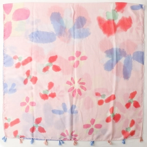 Detailed close-up of light pink scarf with watercolor floral patterns and fringe tassels