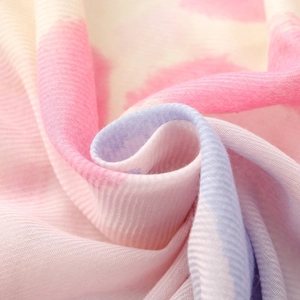 Close-up of soft twill weave scarf fabric with pink and blue gradient pattern