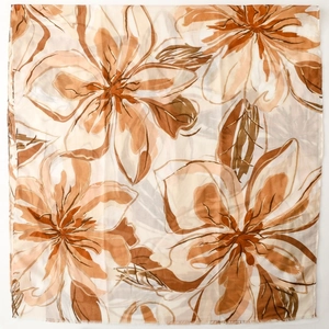 Detail of soft satin scarf with elegant floral prints and fine machine-stitched edges