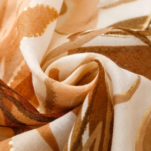 Macro detail of satin scarf with floral patterns and delicate golden foil printing