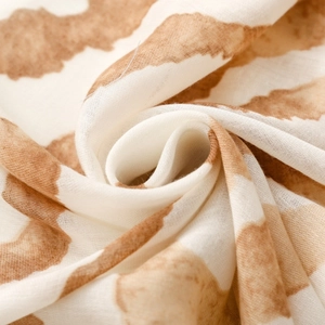 Macro shot of abstract brown zebra pattern scarf showing soft satin texture and fabric weave