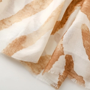 Macro view of zebra print scarf showing soft fabric texture and frayed fringe edges