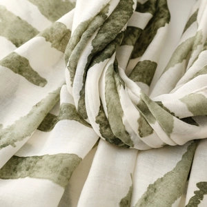 Detailed macro view of olive green and beige zebra print scarf in soft satin fabric