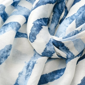 Macro detail of zebra pattern scarf with soft satin texture and abstract blue brushstrokes