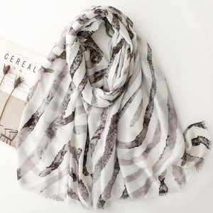 Soft satin scarf with amber zebra print and raw edges on a minimalist white background