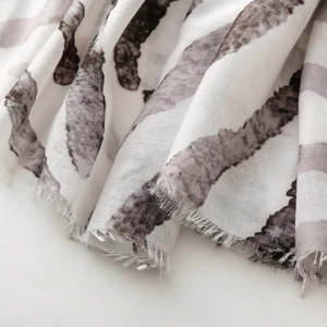 Macro detail of zebra print scarf fabric with soft texture and natural fringe edges
