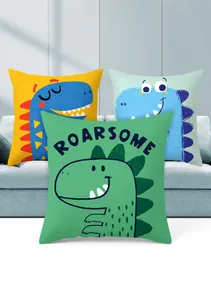 Detail of cartoon dinosaur pillow covers in yellow, green and blue on a sofa