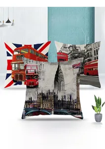 Detail of British style cushion covers with London bus and Big Ben prints on sofa