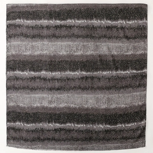 Detail of dark grey striped cotton scarf featuring starry white speckled texture and frayed edges