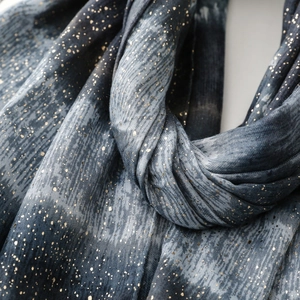 Close-up of gray cotton linen scarf with gold foil accents and blue marble texture