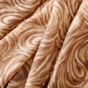 Gros plan sur l'imprimé marbré marron latte avec paillettes dorées sur tissu doux