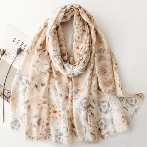 Sciarpa lunga beige con motivi geometrici e nappe su sfondo bianco pulito