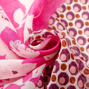 Detail of bohemian scarf showing colorful floral prints and geometric patterns on soft fabric