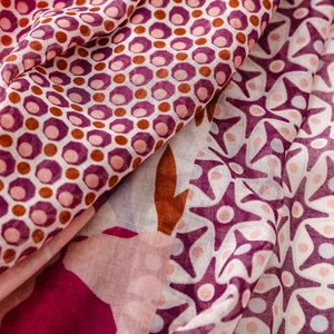Detail of bohemian scarf showing woven cotton-linen texture and purple floral patterns