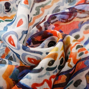 Close-up of colorful paisley flower patterns and woven texture on a lightweight scarf