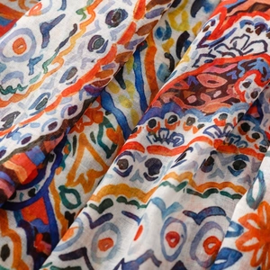 Close-up of bohemian paisley floral pattern on lightweight woven scarf fabric texture
