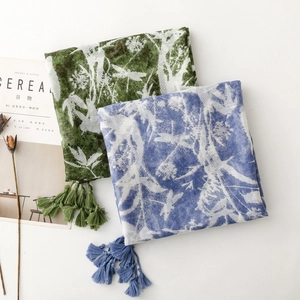 Detailed close-up of vintage floral print scarves with elegant handcrafted tassel edges