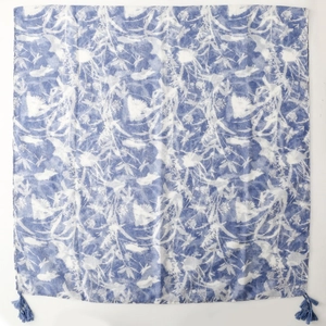 Detailed view of floral blue and white block print scarf with matching fringe tassels