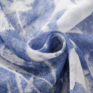 Close-up of lightweight blue and white floral printed fabric with fine mesh texture